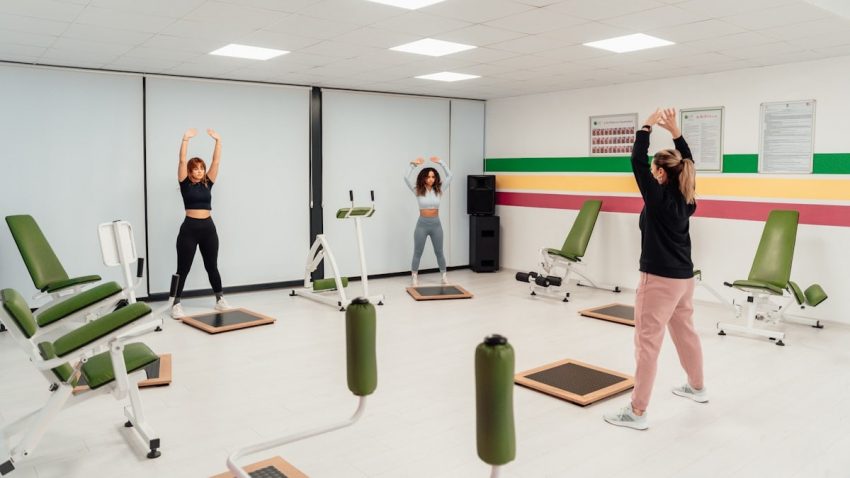 a group of people doing exercises in a gym